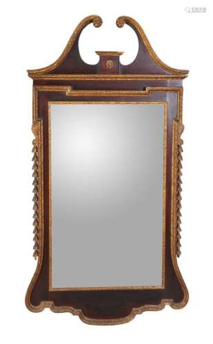 A mahogany and parcel gilt wall mirror