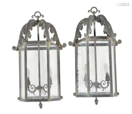 A pair of glazed and metal wall lanterns