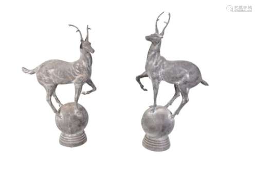 A pair of iron finials modelled as stags