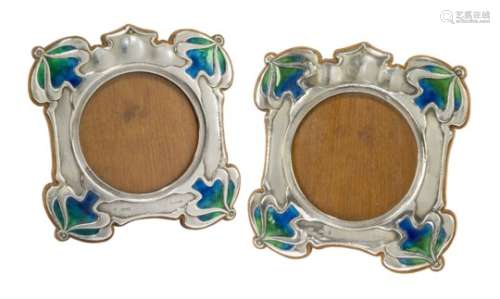 Hutton & Sons, a pair of Art Nouveau silver, oak and enamel photograph frames Mark of Hutton &