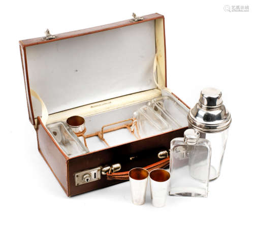 A leather-cased travelling drinks set for four persons, circa 1909,