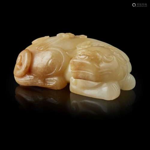 WHITE JADE WITH YELLOW SKIN CARVING OF A BUDDHIST LION QING DYNASTY, 18TH-19TH CENTURY