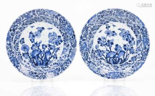 A pair of large scalloped platesBlue underglaze decoration with central composition of rock, flowers