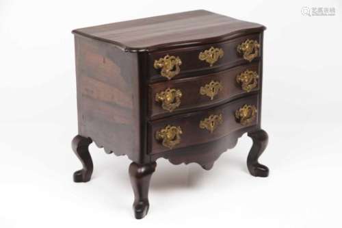 A miniature chest of drawersRosewoodShort legs and scalloped apronThree drawers and yellow metal