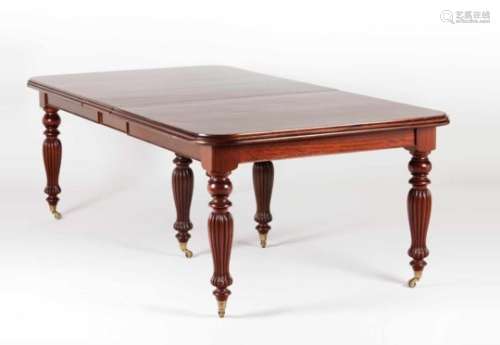 A dining tableBrazilian mahoganyWith four additional leavesScalloped and turned legs with