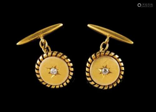 A pair of cufflinksGoldA circle framed by a spiralled ribbon and star set with a central brilliant