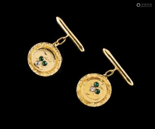 A pair of cufflinksGoldCircular with engraved frieze, set with 4 green and two colourless