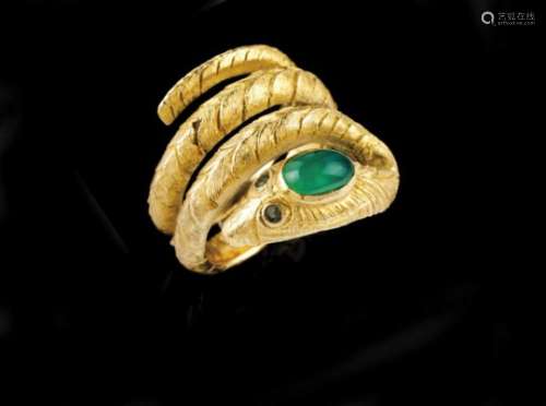 A snake shaped ringGoldChiselled body with head and eyes set with emerald rootUnreadable assay mark,