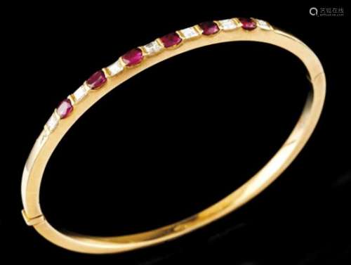 A braceletGold banglePlain band set with 6 oval cut rubies (ca.1.40ct) and 7 princess cut