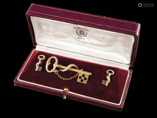 A parurePortuguese gold, 19th centuryKey shaped brooch and earrings set with micro pearlsIn the