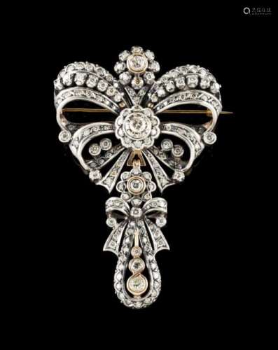 A bow brooch/pendantPortuguese silver and goldThe bow set with 2 brilliant cut diamonds (ca.1.30ct),