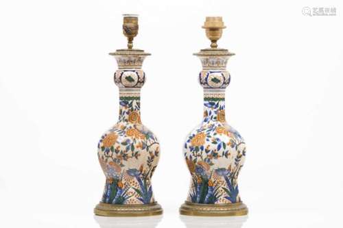 A pair of bottlesDelft faiencePolychrome decoration19th/20th century(adapted to lamps)Height: 45,5