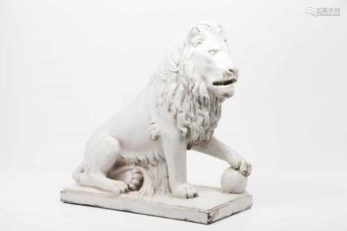 A seated lionWhite faience of blue iridescent decoration produced by Fábrica das Devesas from Vila