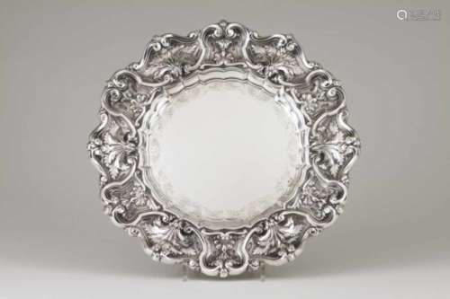 A salverPortuguese silverPlain chiselled border base and scalloped rim of profuse raised floral
