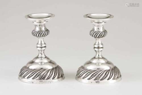 A pair of candlesticksPortuguese silver17th century style decorationHammered and spiralled stand and
