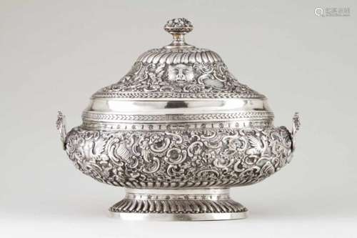 An important tureenPortuguese silverThe base and cover profusely decorated with repoussé and