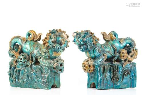 PAIR OF LARGE GREEN GLAZED POTTERY LION FIGURES