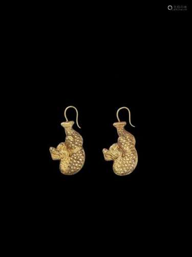 A PAIR OF CHAM REPOUSSÉ GOLD EAR ORNAMENTS IN THE …