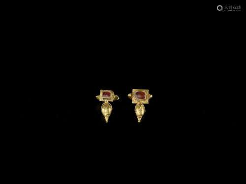 A PAIR OF CHAM GOLD EAR ORNAMENTS WITH RED GEMSTON…
