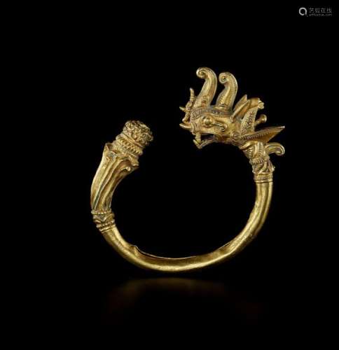 A THAI GOLD BANGLE WITH A DRAGON HEAD AND LOTUS FL…