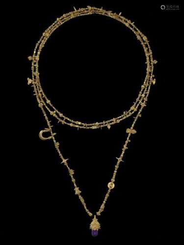 A LONG INDIAN GOLD NECKLACE WITH A LOTUS PENDANT A…