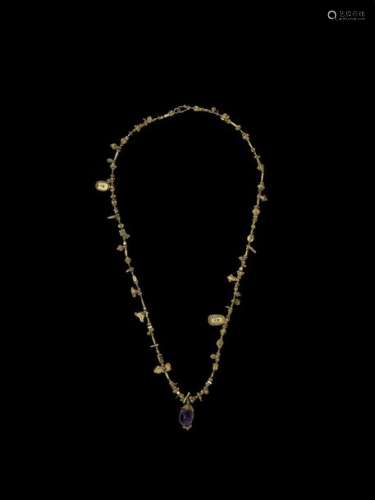 AN INDIAN GOLD NECKLACE WITH A LOTUS PENDANT AND A…