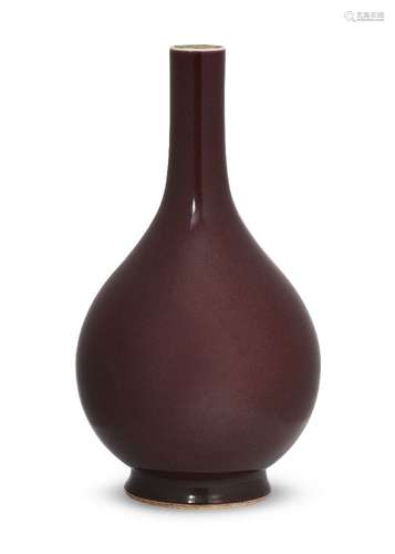 A Chinese monochrome porcelain bottle vase, 18th century, with allover copper-red glaze, 31.5cm high