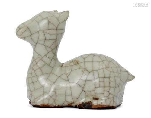 A Chinese porcelain Guan-type scroll weight, 18th century, modelled as a recumbent deer covered in a