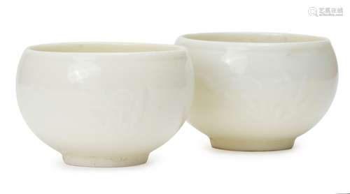 A pair of Chinese blanc de chine porcelain cups, Republic period, moulded with floral sprays, 6.