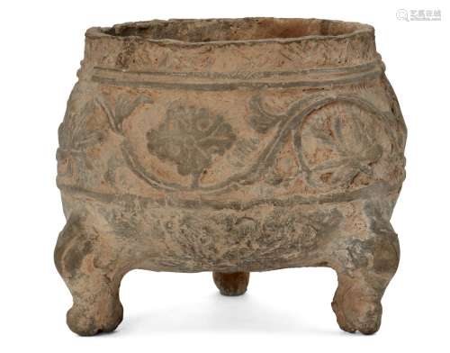 A Chinese grey pottery tripod vessel, Han dynasty, decorated in relief to the body with a band of