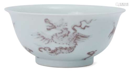 A Chinese porcelain ogee 'mythical beasts' bowl, late Qing dynasty, painted in underglaze copper red