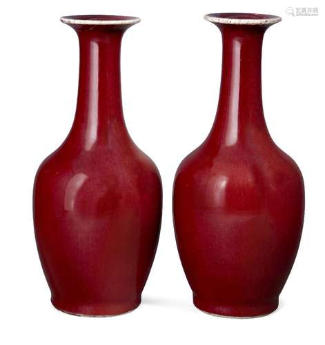 A pair of Chinese porcelain sang de boeuf bottle vases, late Qing/Republic period, with flared rims,