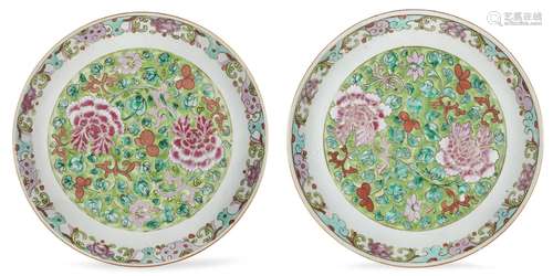 A pair of Chinese porcelain dishes, 19th century, painted in famille rose with peonies on a green