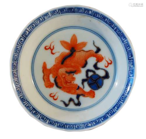 A Chinese porcelain saucer dish, 20th century, painted in underglaze blue and iron red, the