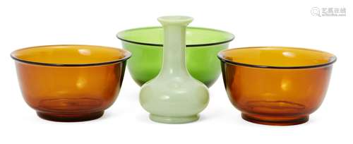 Three Chinese Peking glass bowls and a lime green glass bottle vase, early 20th century, two bowls