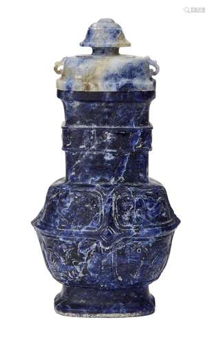 A Chinese archaistic lapis vase and cover, 18th/19th century, carved to the body with panels of