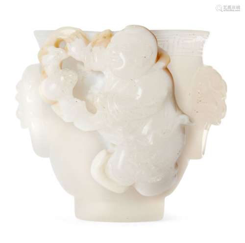 A Chinese agate cup, 18th/19th century, finely carved with a boy holding a bat, with lion mask and