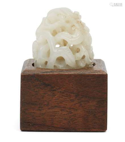 A Chinese pale green jade Yuan style finial, early 20th century, carved with leafy scrolls, 4cm