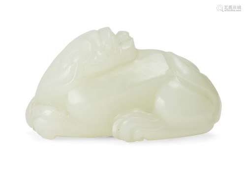 A Chinese pale green jade carving of a Buddhist lion, late Qing dynasty, carved in a recumbent