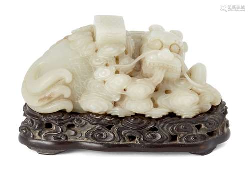 A large Chinese celadon jade bixi carving, late Qing/Republic period, the recumbent bixi issuing