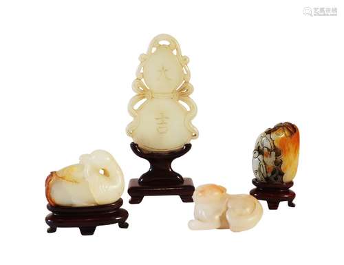 Four Chinese pale green and black jade carvings, late Qing dynasty, comprising a double gourd