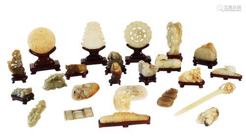 A collection of twenty-four Chinese green jade and hardstone carvings, 20th century, to include