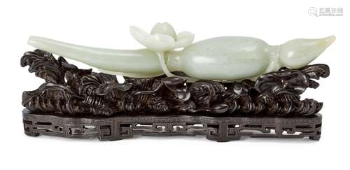 A Chinese pale green jade lotus brush rest, 18th century, carved as a lotus bud and flower, on