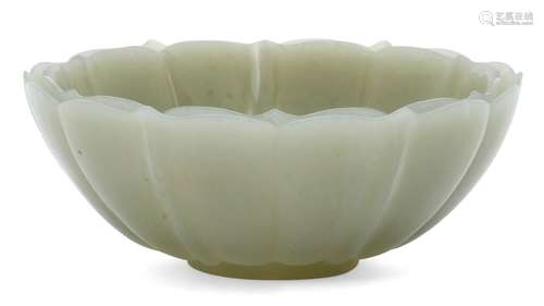 A Chinese celadon jade 'lotus' bowl, late Qing dynasty, carved as a lotus flower, with shaped rim,