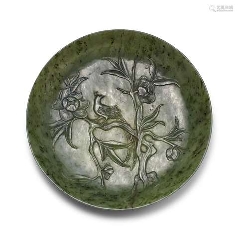 A Chinese spinach jade marriage dish, late Qing dynasty, carved in low relief with an exotic bird