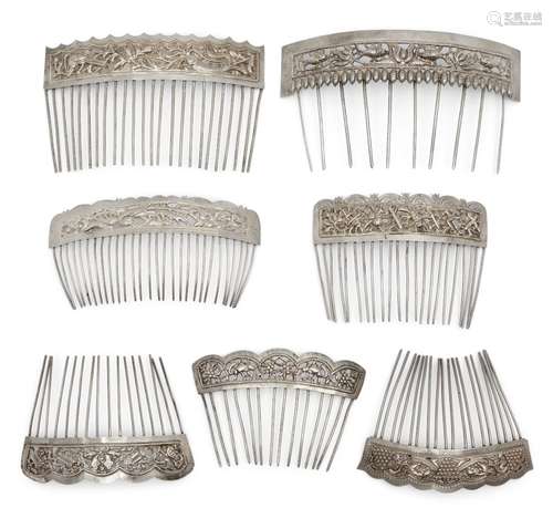 Eight Chinese silver hair combs, 20th century, each repousse decorated with various auspicious