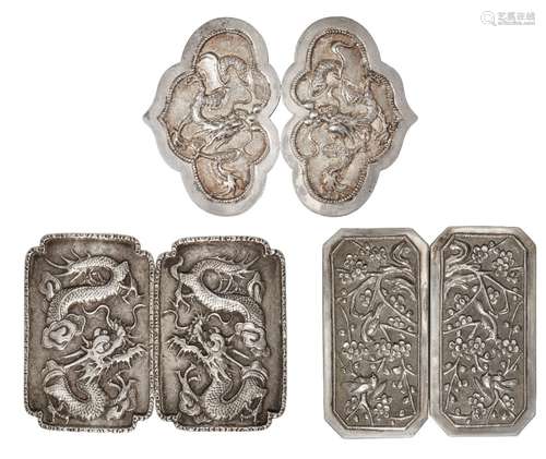 Three Chinese silver two-piece buckles, early 20th century, two repousse-decorated with dragons, the