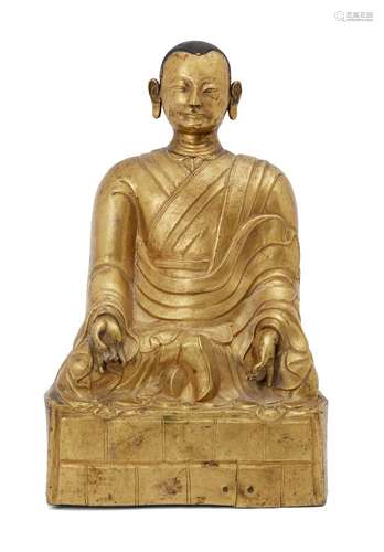 A Chinese gilt-copper figure of a Lohan, late Qing dynasty, seated in dhyasana, wearing flowing