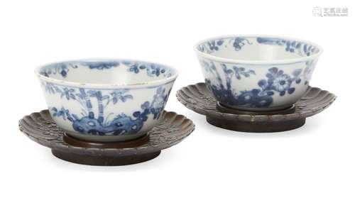 A pair of Chinese porcelain tea bowls, Kangxi period, painted in underglaze blue with bamboo and