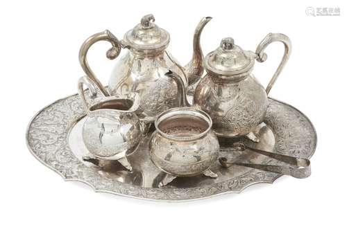 A Burmese white metal four-piece tea set and tray, 20th century, each embossed with deities and